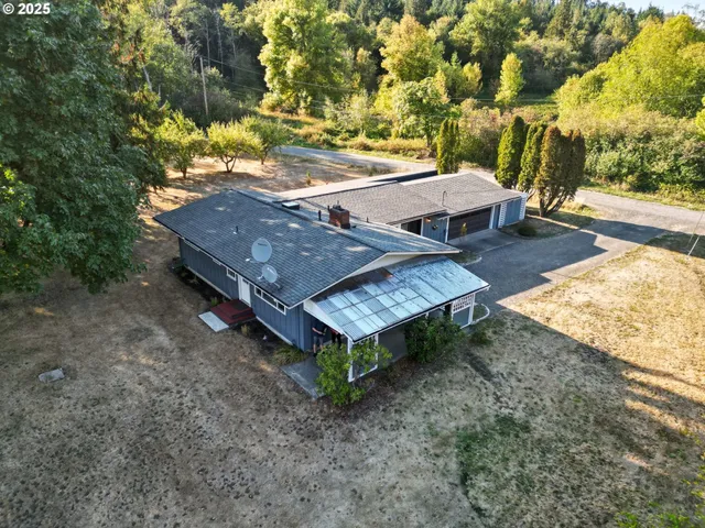 an aerial view of a house with a yard table and chairs