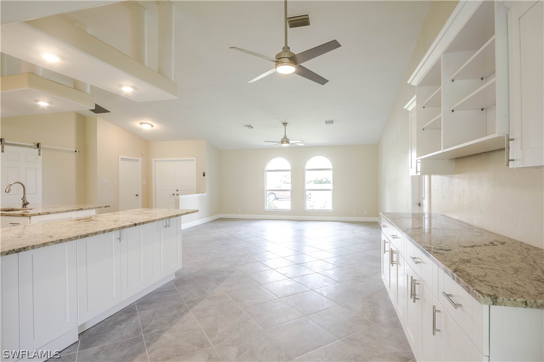 2871 Styles Road Alva, FL 33920 - Photo 11 of 33 a bathroom with a granite countertop sink a large mirror and vanity