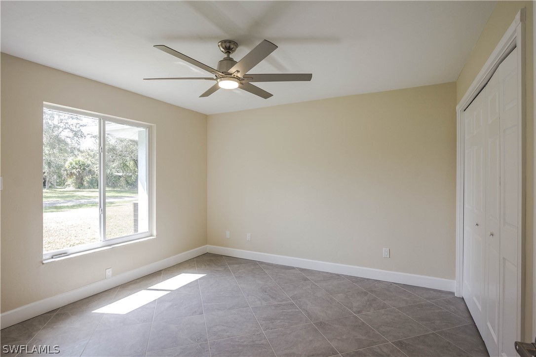 2871 Styles Road Alva, FL 33920 - Photo 17 of 33 an empty room with windows and fan