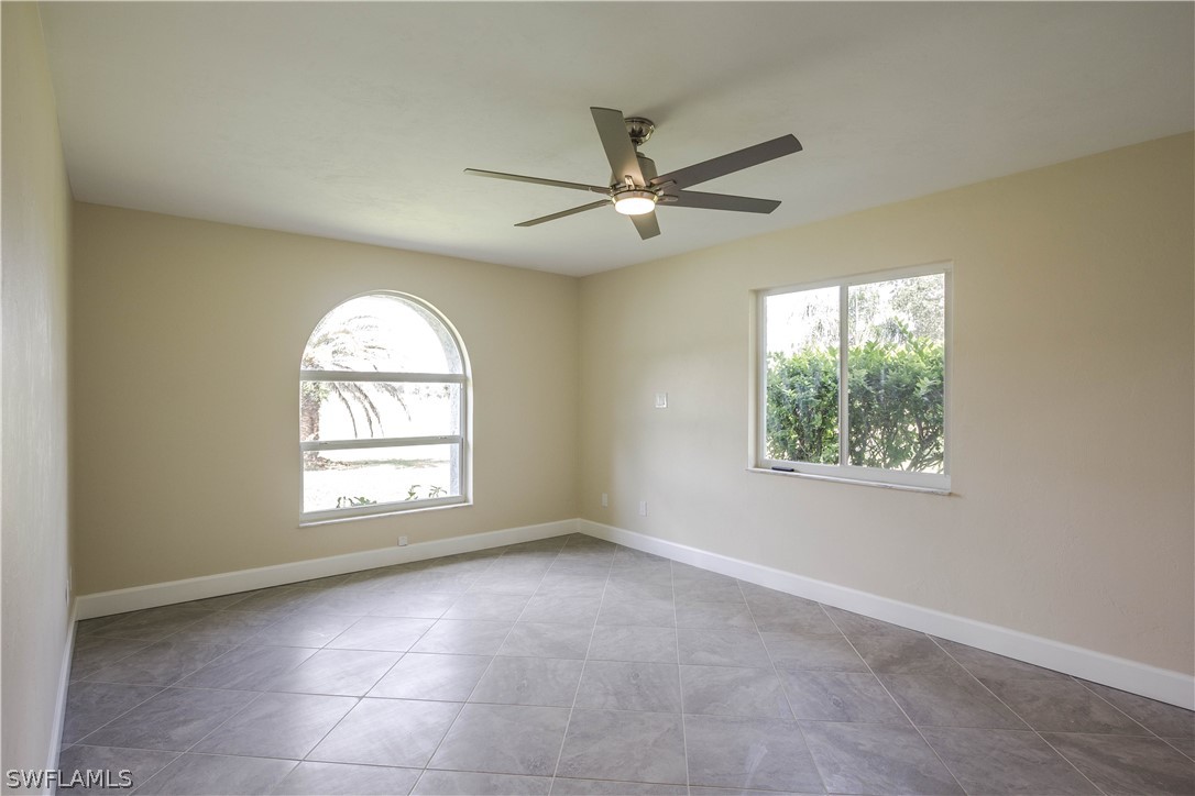 2871 Styles Road Alva, FL 33920 - Photo 18 of 33 an empty room with windows and fan