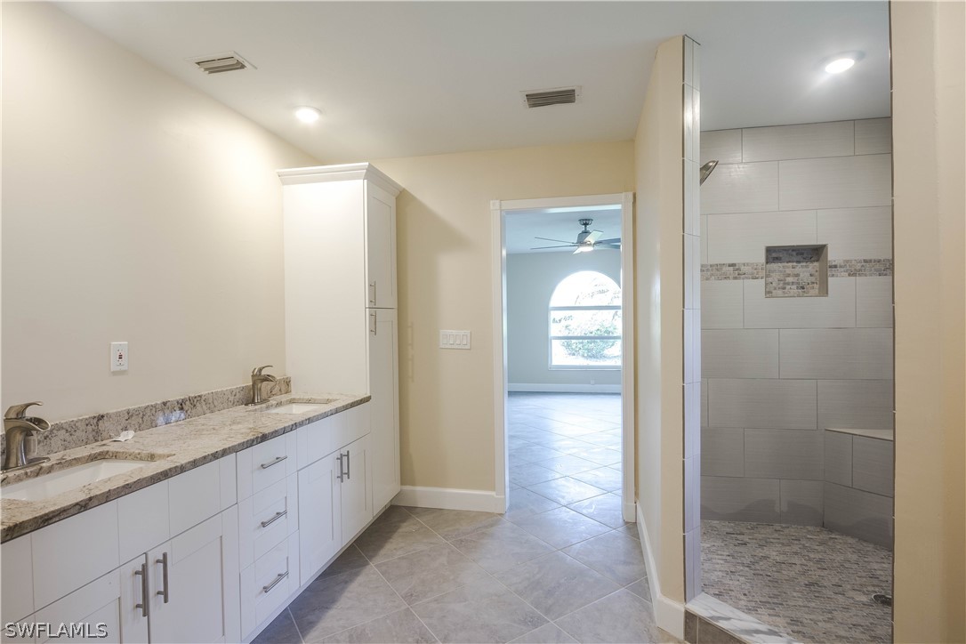 2871 Styles Road Alva, FL 33920 - Photo 23 of 33 a bathroom with a granite countertop sink mirror and shower