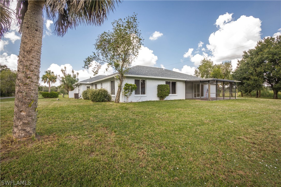 2871 Styles Road Alva, FL 33920 - Photo 27 of 33 a front view of a house with a garden