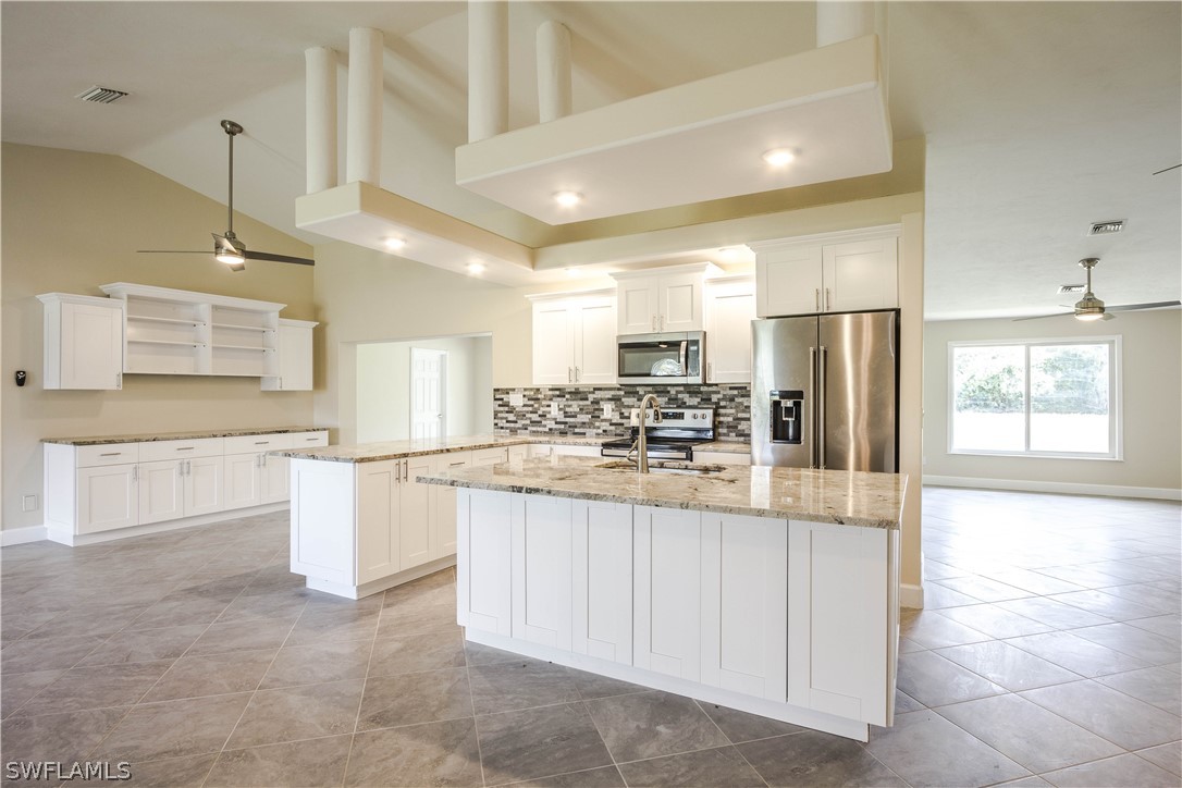 2871 Styles Road Alva, FL 33920 - Photo 5 of 33 a kitchen with stainless steel appliances kitchen island granite countertop a refrigerator and a sink