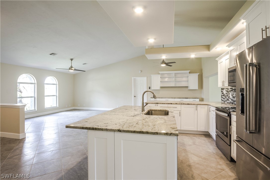 2871 Styles Road Alva, FL 33920 - Photo 10 of 33 a kitchen with stainless steel appliances granite countertop a sink and a refrigerator