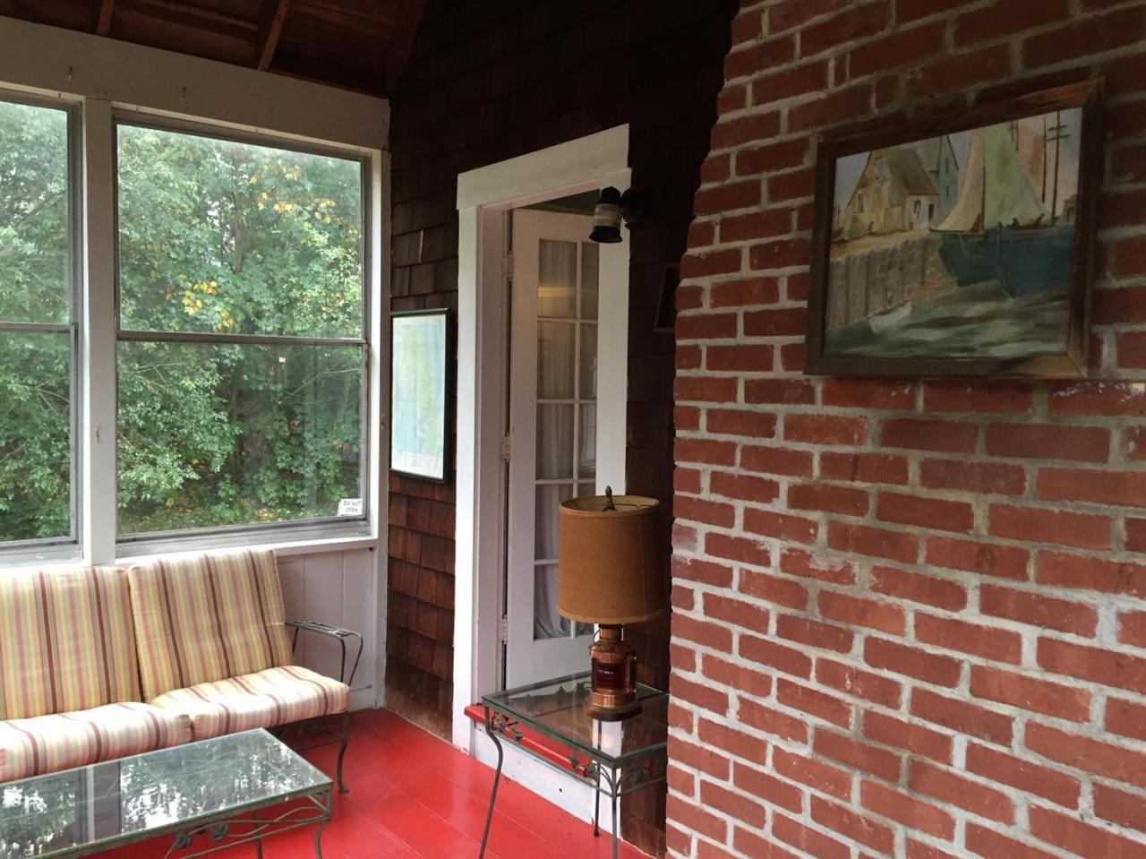 65 Mill Hill Road Wellfleet, MA 02667 - Photo 11 of 17 a view of a brick house with a large window