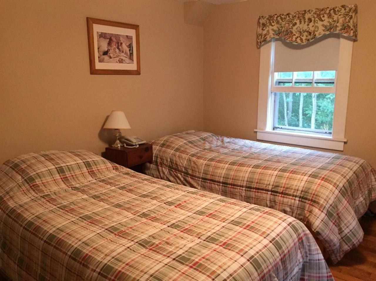 65 Mill Hill Road Wellfleet, MA 02667 - Photo 15 of 17 a bedroom with two beds and a window