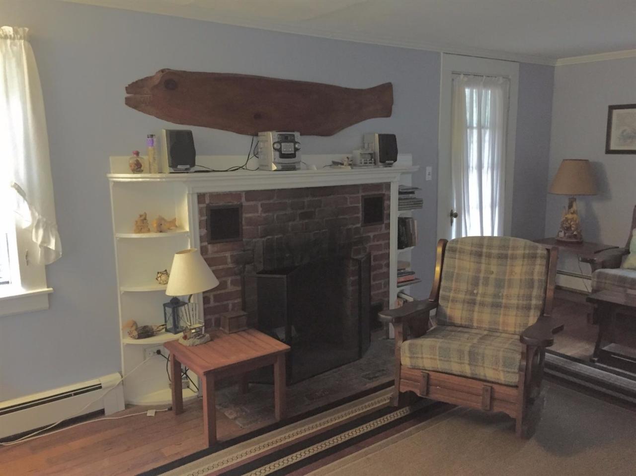 65 Mill Hill Road Wellfleet, MA 02667 - Photo 4 of 17 a living room with furniture and a fireplace