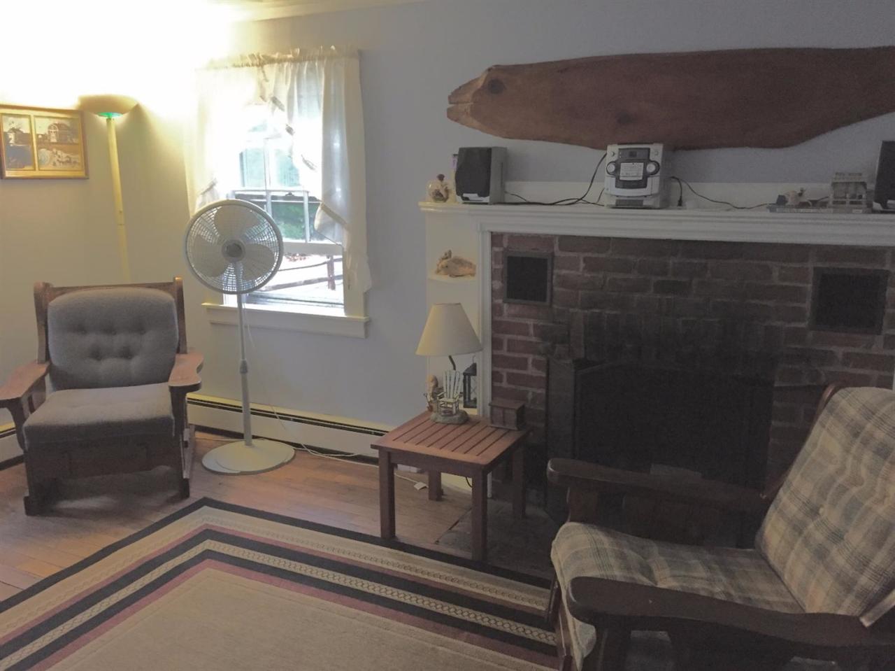 65 Mill Hill Road Wellfleet, MA 02667 - Photo 5 of 17 a living room with furniture and a chair