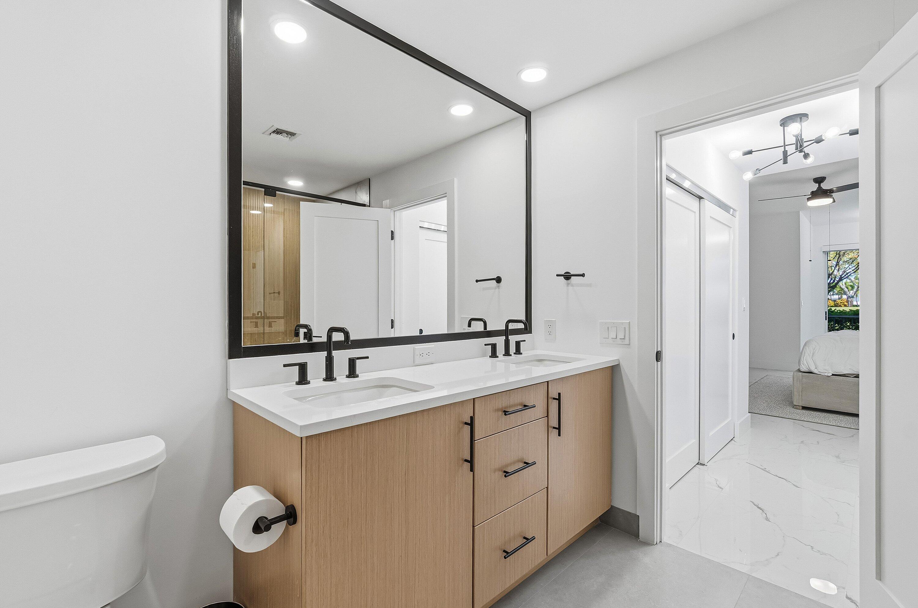 5082 Lake Catalina Drive, Unit A Boca Raton, FL 33496 - Photo 16 of 35 a spacious bathroom with a double vanity sink toilet and shower