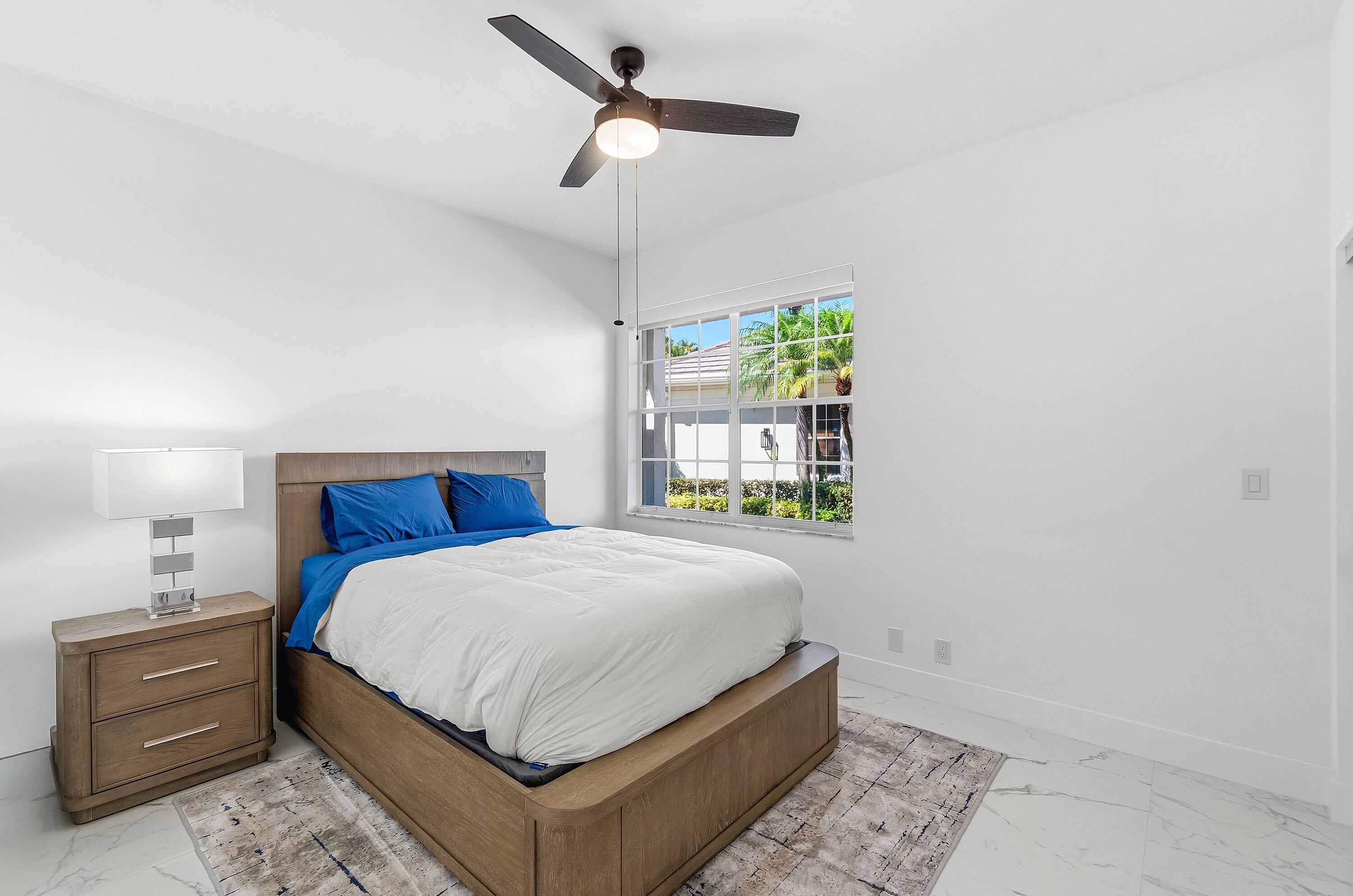 5082 Lake Catalina Drive, Unit A Boca Raton, FL 33496 - Photo 18 of 35 a bedroom with a bed and a window