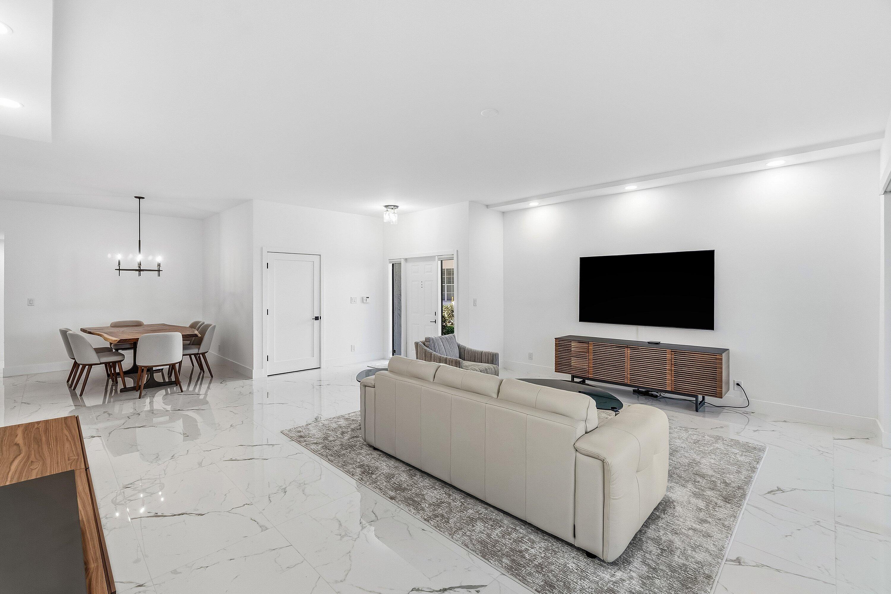 5082 Lake Catalina Drive, Unit A Boca Raton, FL 33496 - Photo 3 of 35 a living room with furniture and a flat screen tv