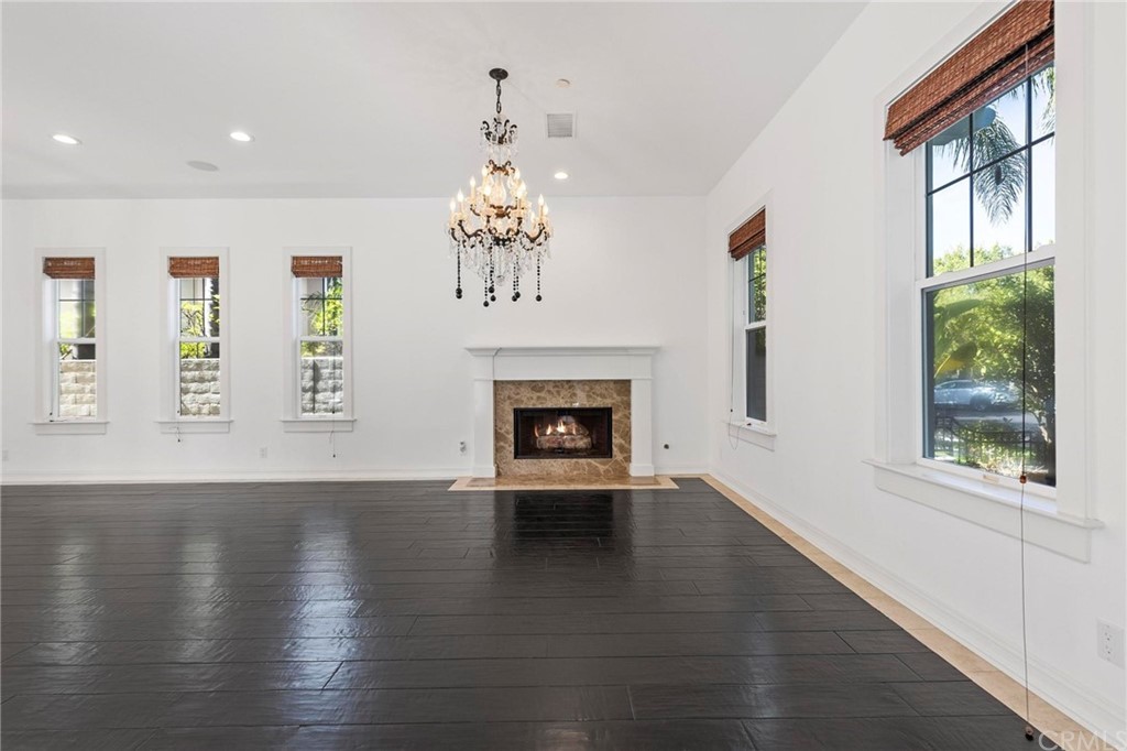 3 Seabluff Newport Beach, CA 92660 - Photo 11 of 75 an empty room with wooden floor fireplace and windows