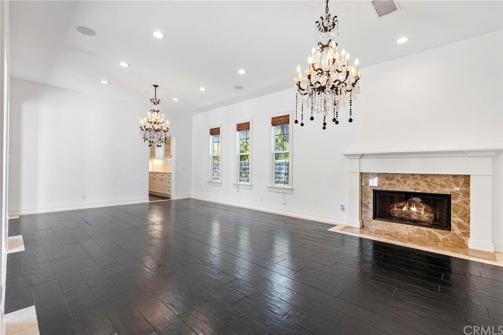 3 Seabluff Newport Beach, CA 92660 - Photo 12 of 75 a view of an empty room with chandelier and wooden floor