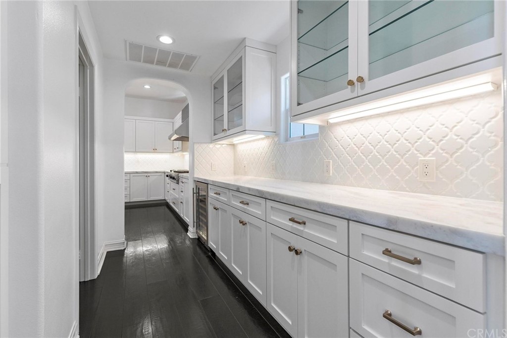 3 Seabluff Newport Beach, CA 92660 - Photo 17 of 75 a kitchen with granite countertop white cabinets and white appliances
