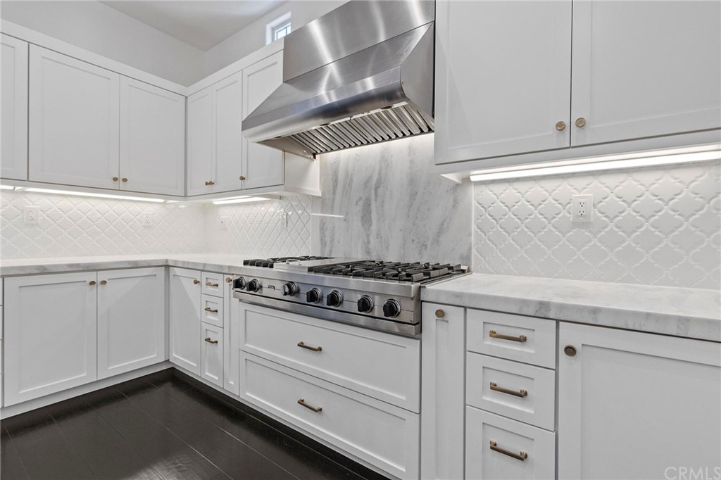 3 Seabluff Newport Beach, CA 92660 - Photo 20 of 75 a kitchen with white cabinets and appliances