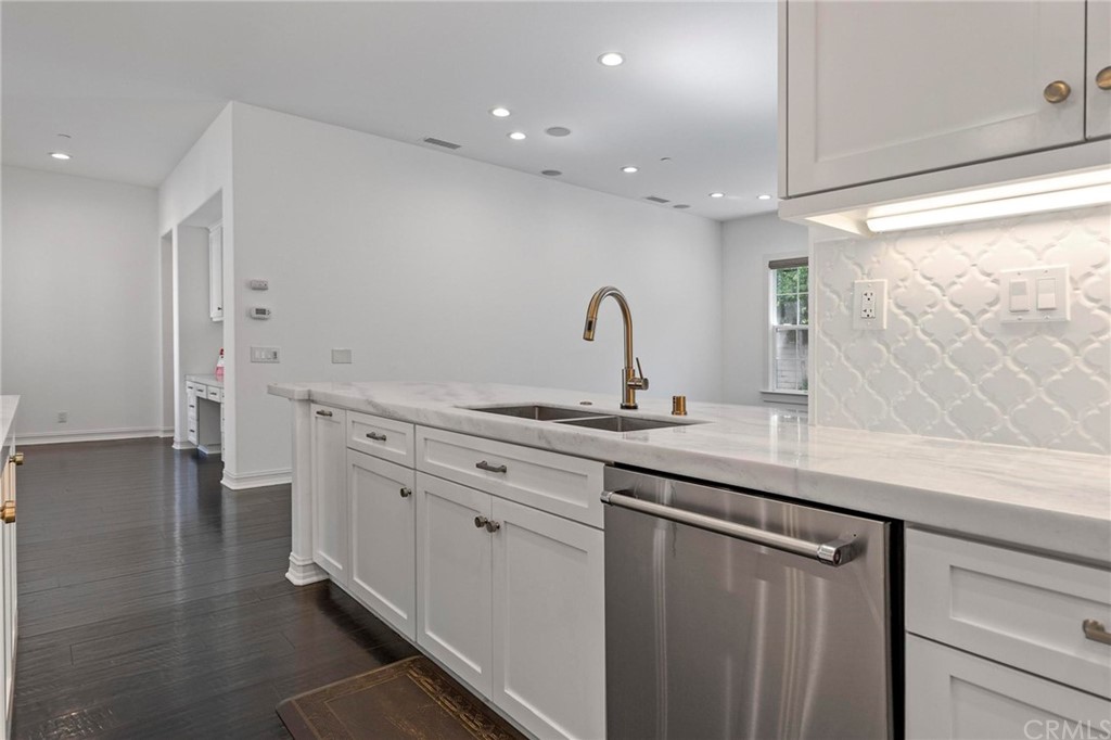 3 Seabluff Newport Beach, CA 92660 - Photo 23 of 75 a kitchen with stainless steel appliances a sink stove and cabinets