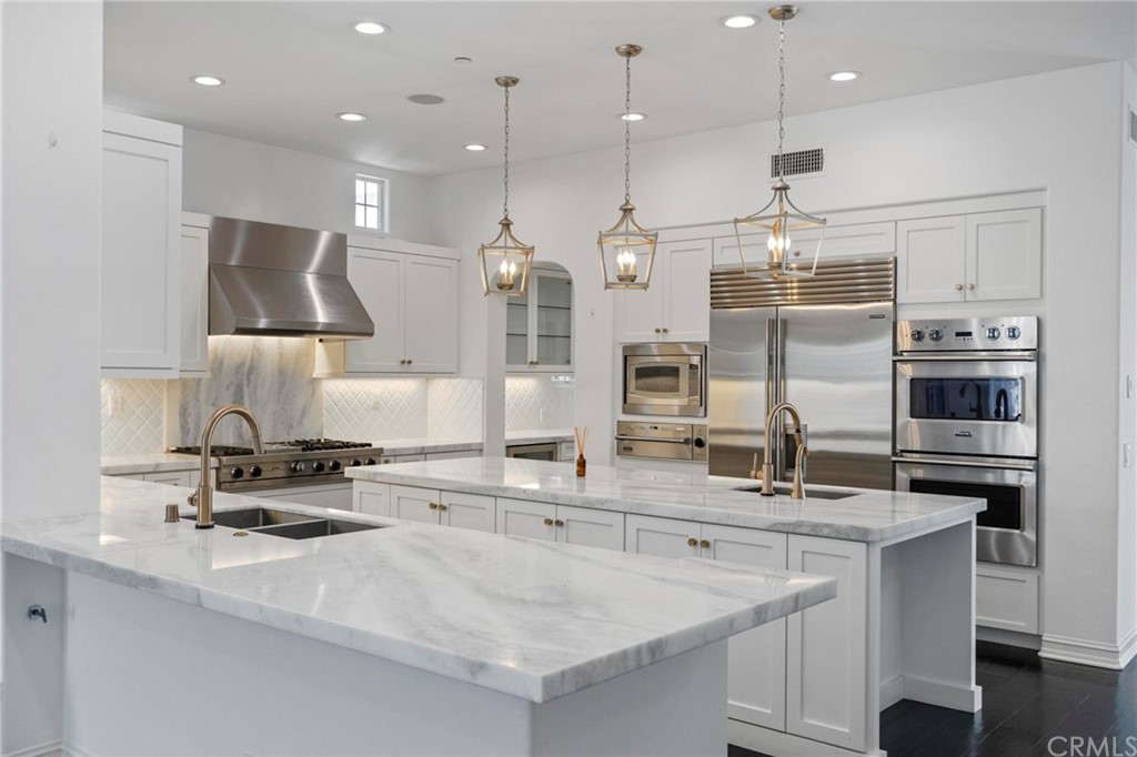 3 Seabluff Newport Beach, CA 92660 - Photo 29 of 75 a kitchen with stainless steel appliances kitchen island granite countertop a sink a stove and a refrigerator