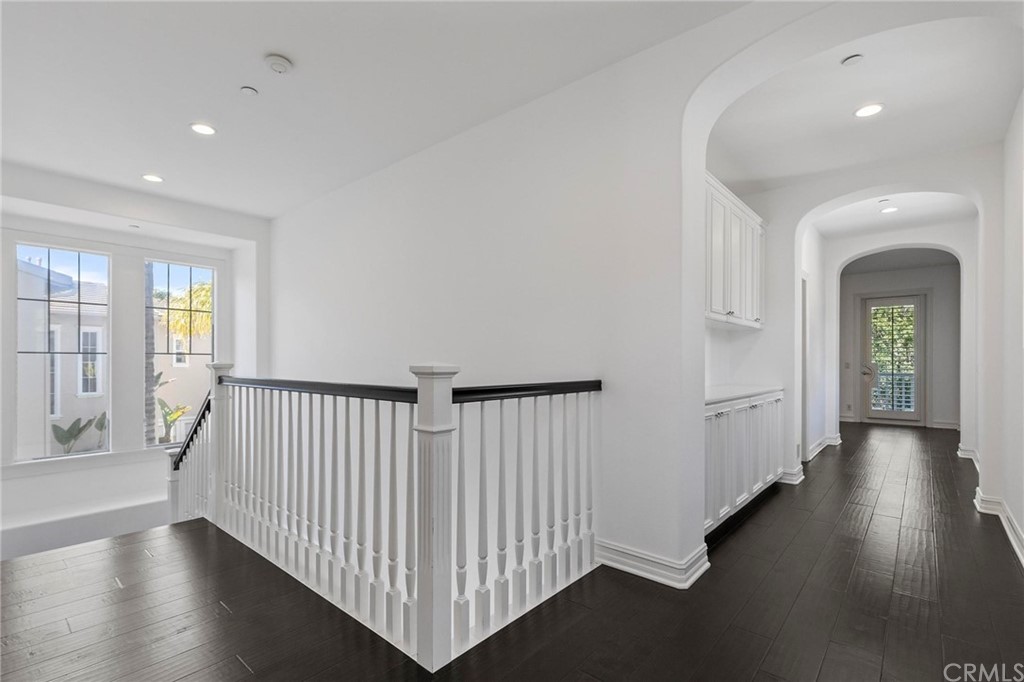 3 Seabluff Newport Beach, CA 92660 - Photo 36 of 75 a view of a hallway with wooden floor and windows