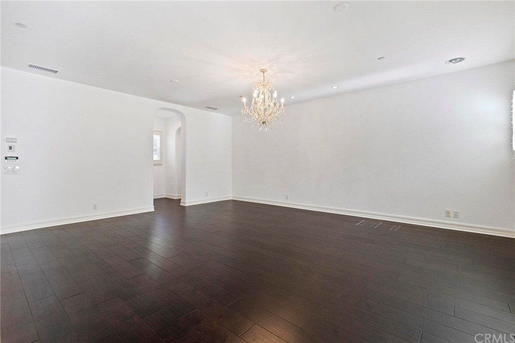 3 Seabluff Newport Beach, CA 92660 - Photo 40 of 75 an empty room with wooden floor and chandelier fan
