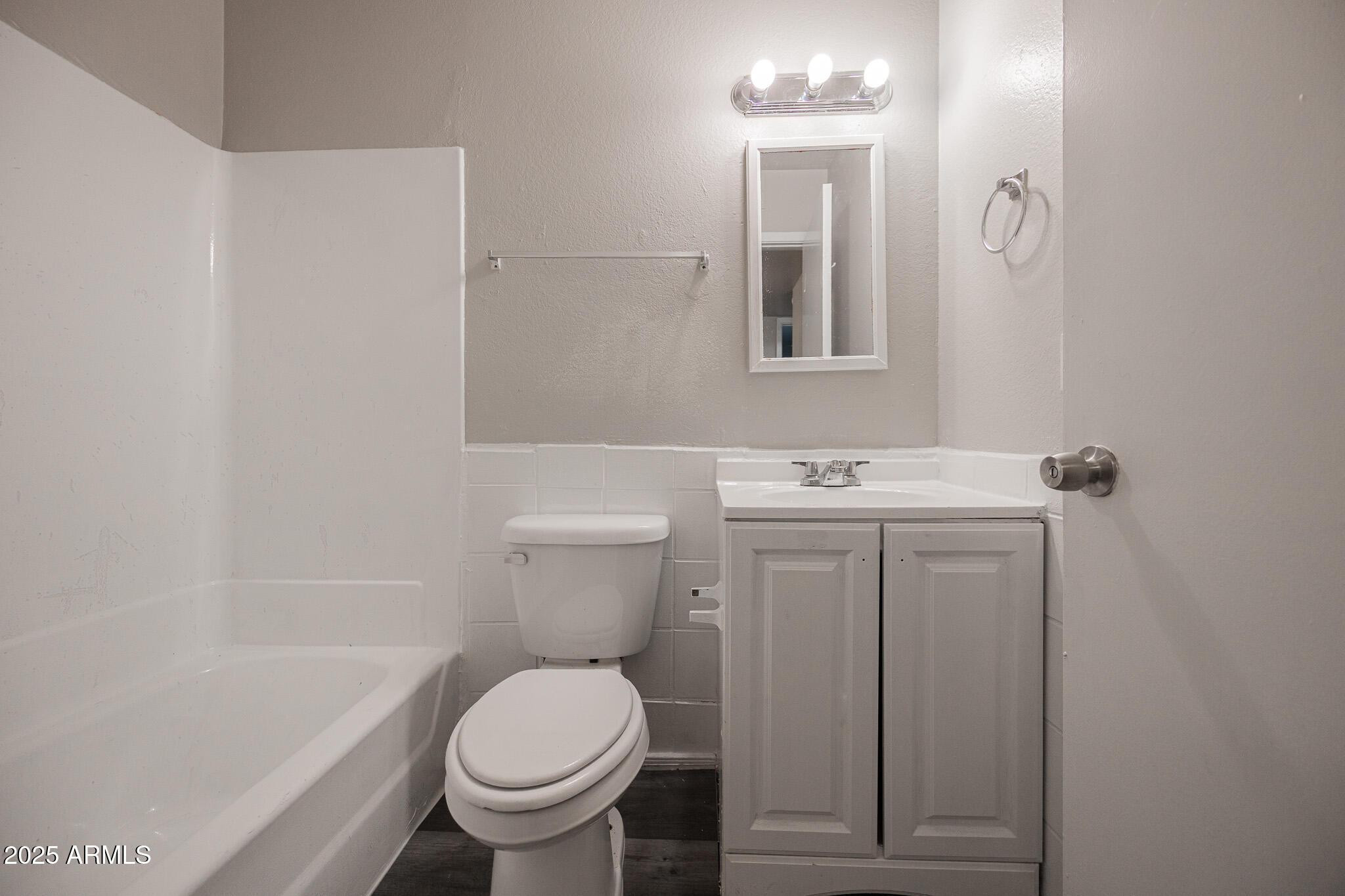 1703 West Mountain View Road, Unit 14 Phoenix, AZ 85021 - Photo 13 of 14 a white toilet sitting next to a bathroom sink