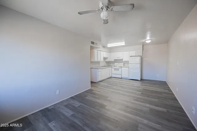 a view of a kitchen with a dishwasher and wooden floor