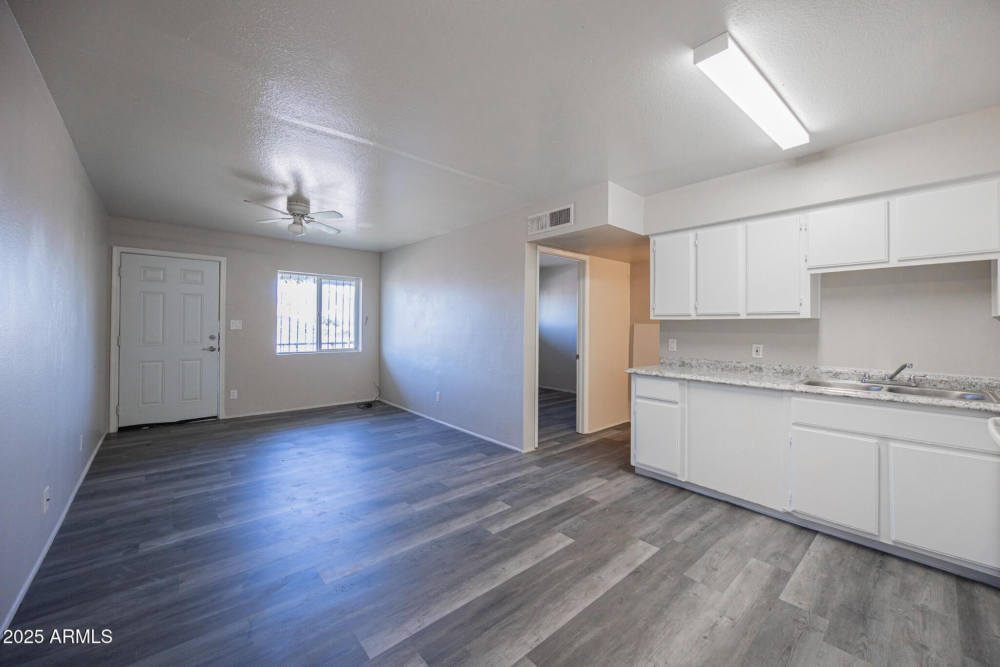 1703 West Mountain View Road, Unit 14 Phoenix, AZ 85021 - Photo 7 of 14 a view of a kitchen cabinets and wooden floor