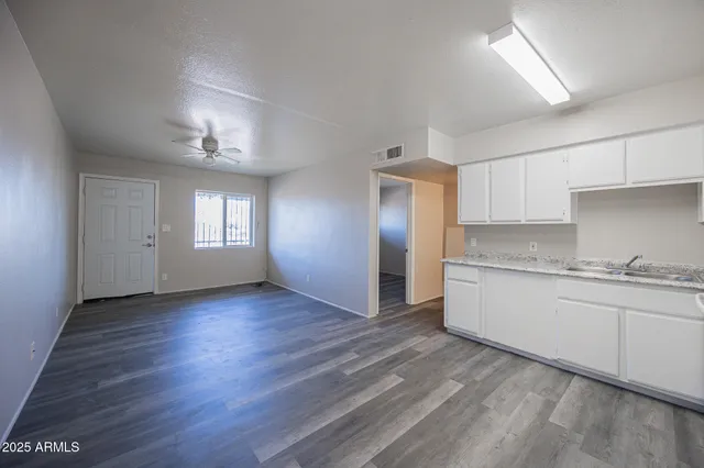 a view of a kitchen and a sink window wooden floor
