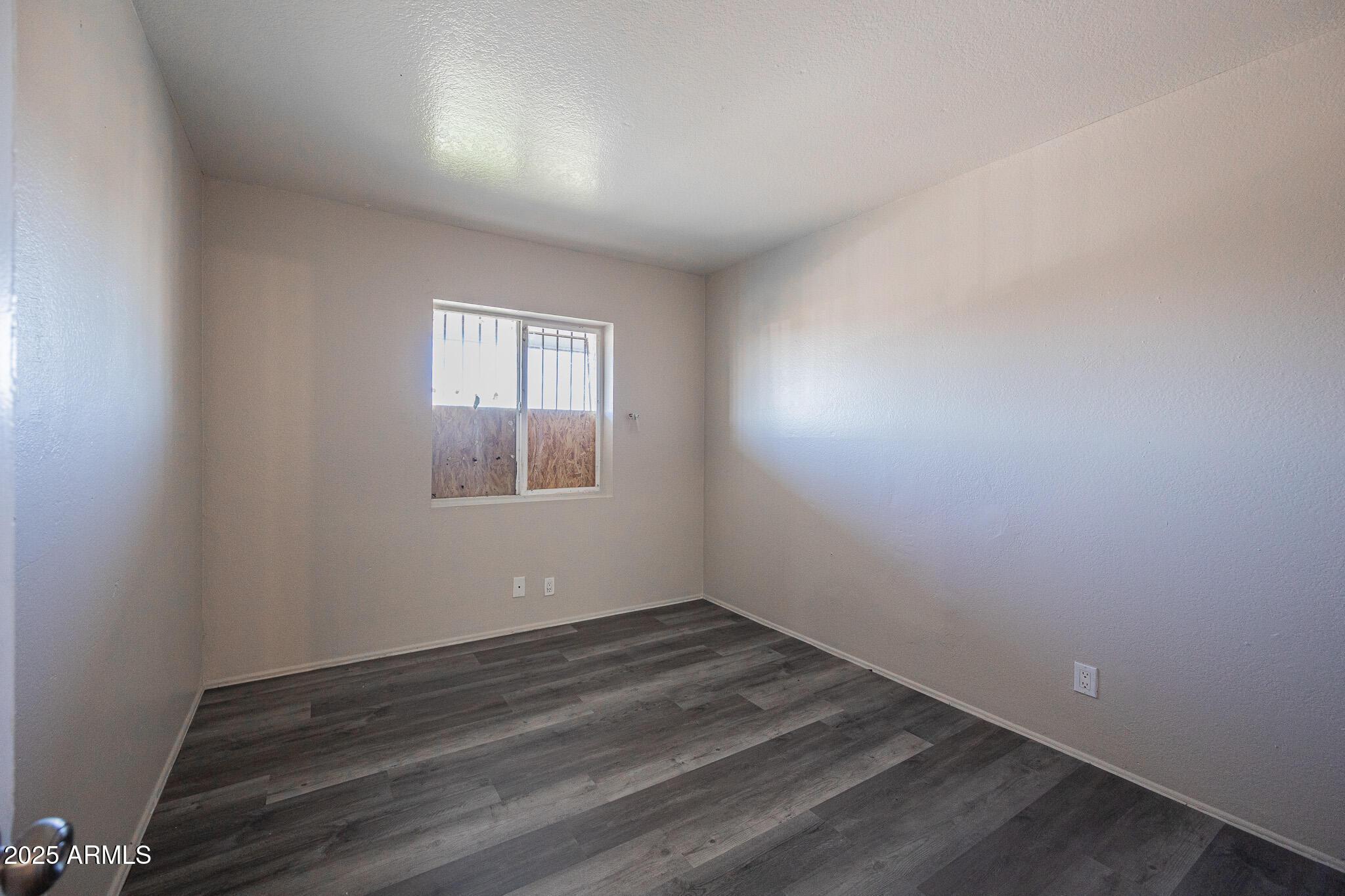 1703 West Mountain View Road, Unit 14 Phoenix, AZ 85021 - Photo 9 of 14 an empty room with a window