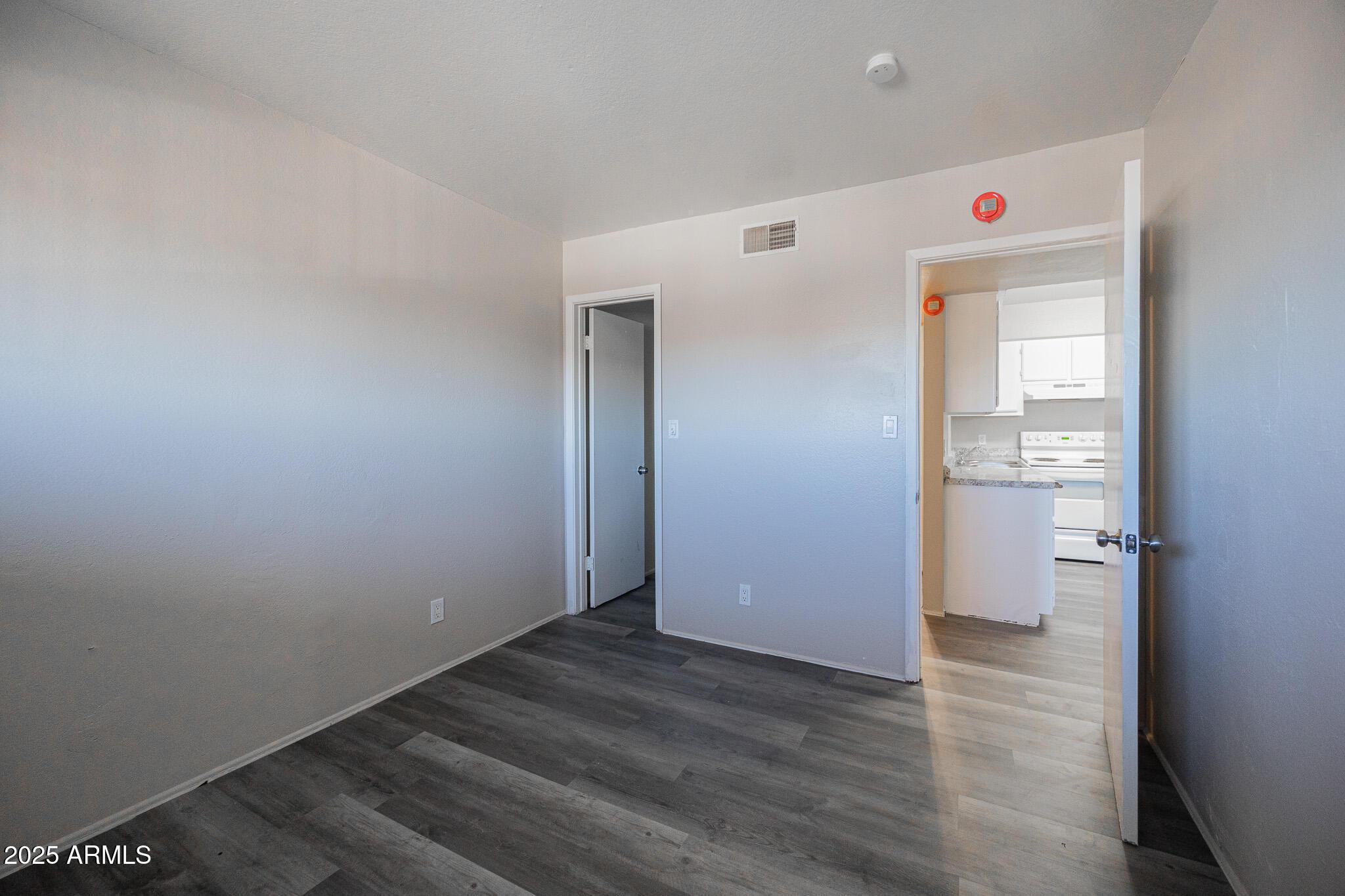 1703 West Mountain View Road, Unit 14 Phoenix, AZ 85021 - Photo 10 of 14 a view of a hallway with wooden floor
