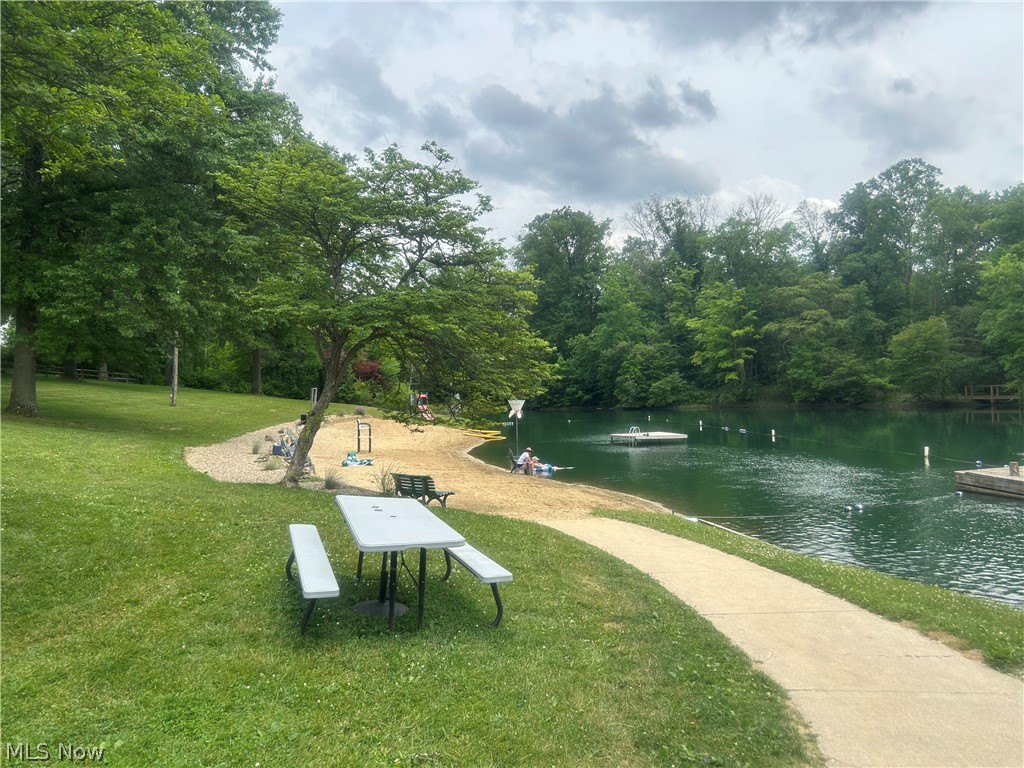 824 South Chillicothe Road, Unit 2 Aurora, OH 44202 - Photo 39 of 42 Waterfront property featuring a sandy beach area, mature trees, and an expansive lawn