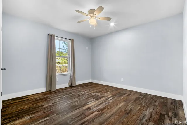 wooden floor in an empty room with a window