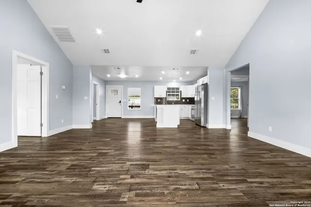 a view of kitchen with kitchen island refrigerator stove and cabinets