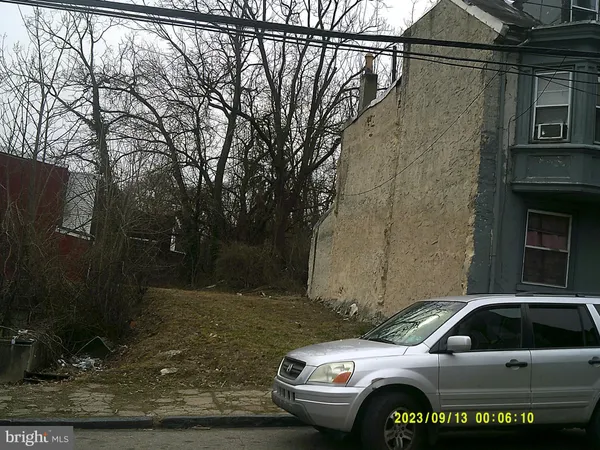 a view of parking with a car parked in front of it