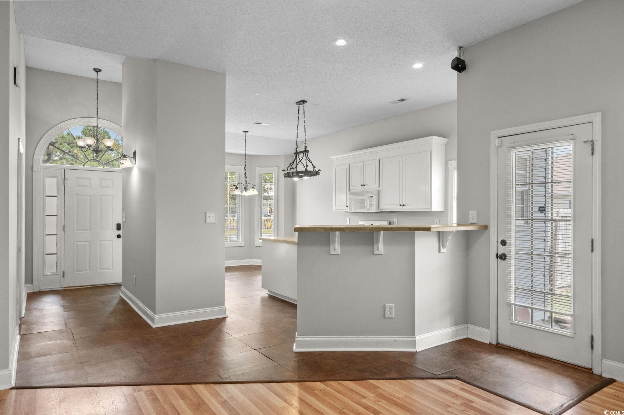 2723 Canvasback Trail Myrtle Beach, SC 29588 - Photo 11 of 40 Foyer entrance featuring a chandelier, dark wood-style flooring, a textured ceiling, plenty of natural light, and recessed lighting