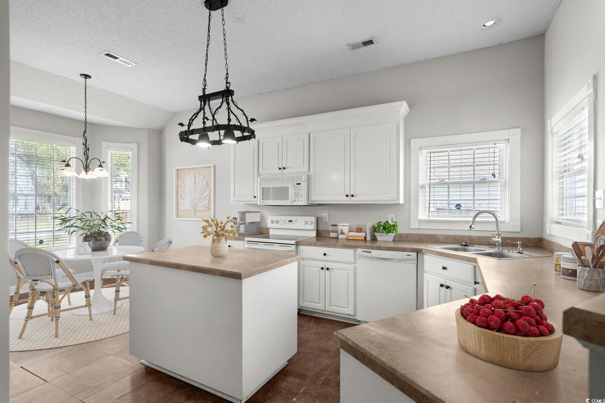 2723 Canvasback Trail Myrtle Beach, SC 29588 - Photo 13 of 40 Kitchen featuring a kitchen island, white cabinetry, decorative light fixtures, white appliances, and light countertops