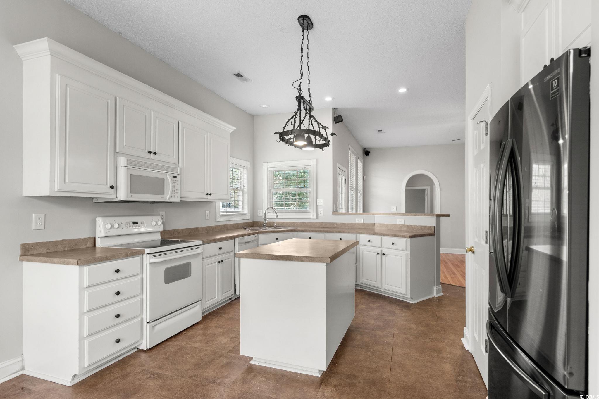 2723 Canvasback Trail Myrtle Beach, SC 29588 - Photo 14 of 40 Kitchen with white appliances, white cabinetry, a kitchen island, pendant lighting, and recessed lighting