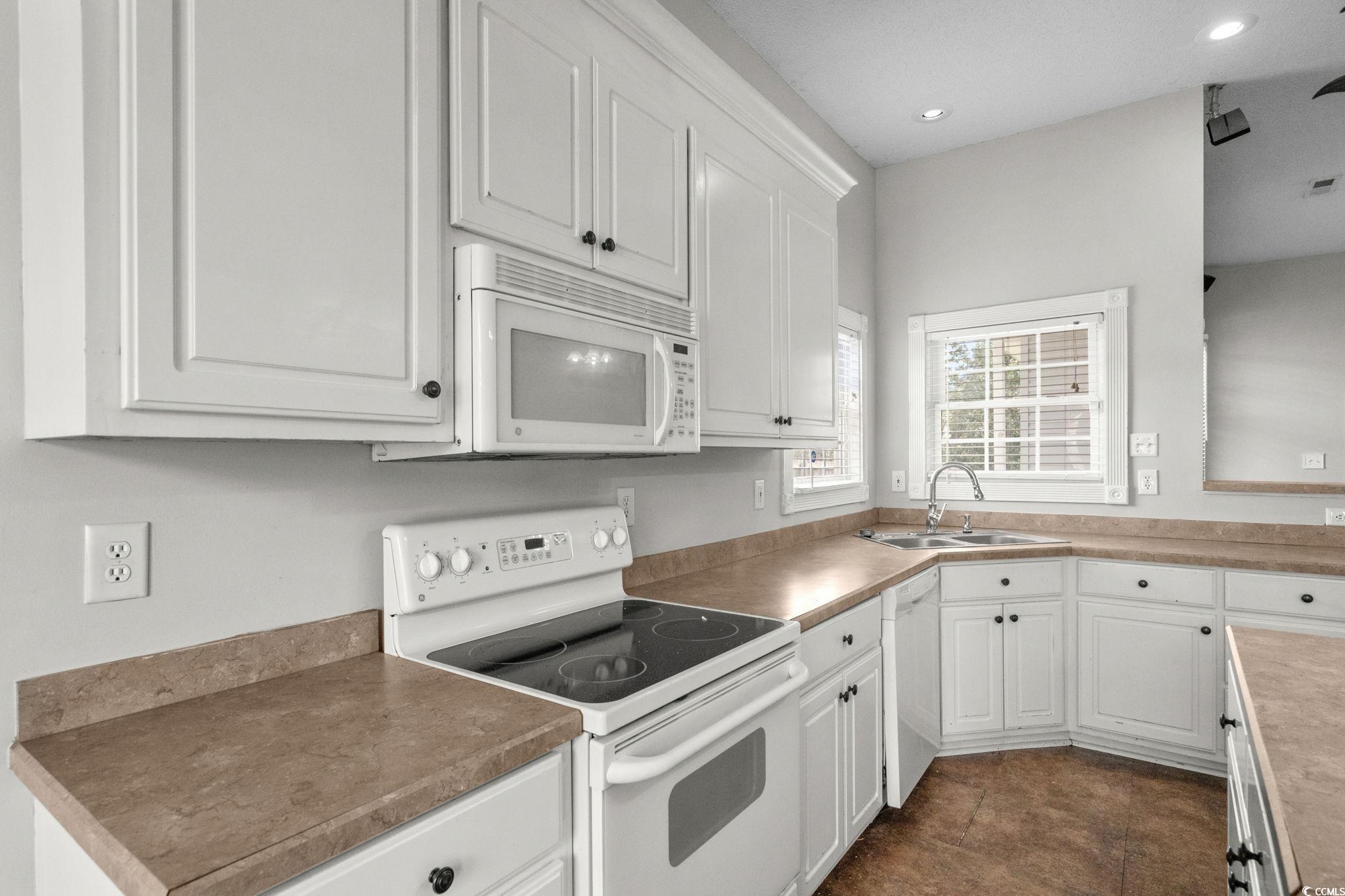 2723 Canvasback Trail Myrtle Beach, SC 29588 - Photo 15 of 40 Kitchen featuring white appliances, white cabinets, recessed lighting, dark tile patterned floors, and light countertops
