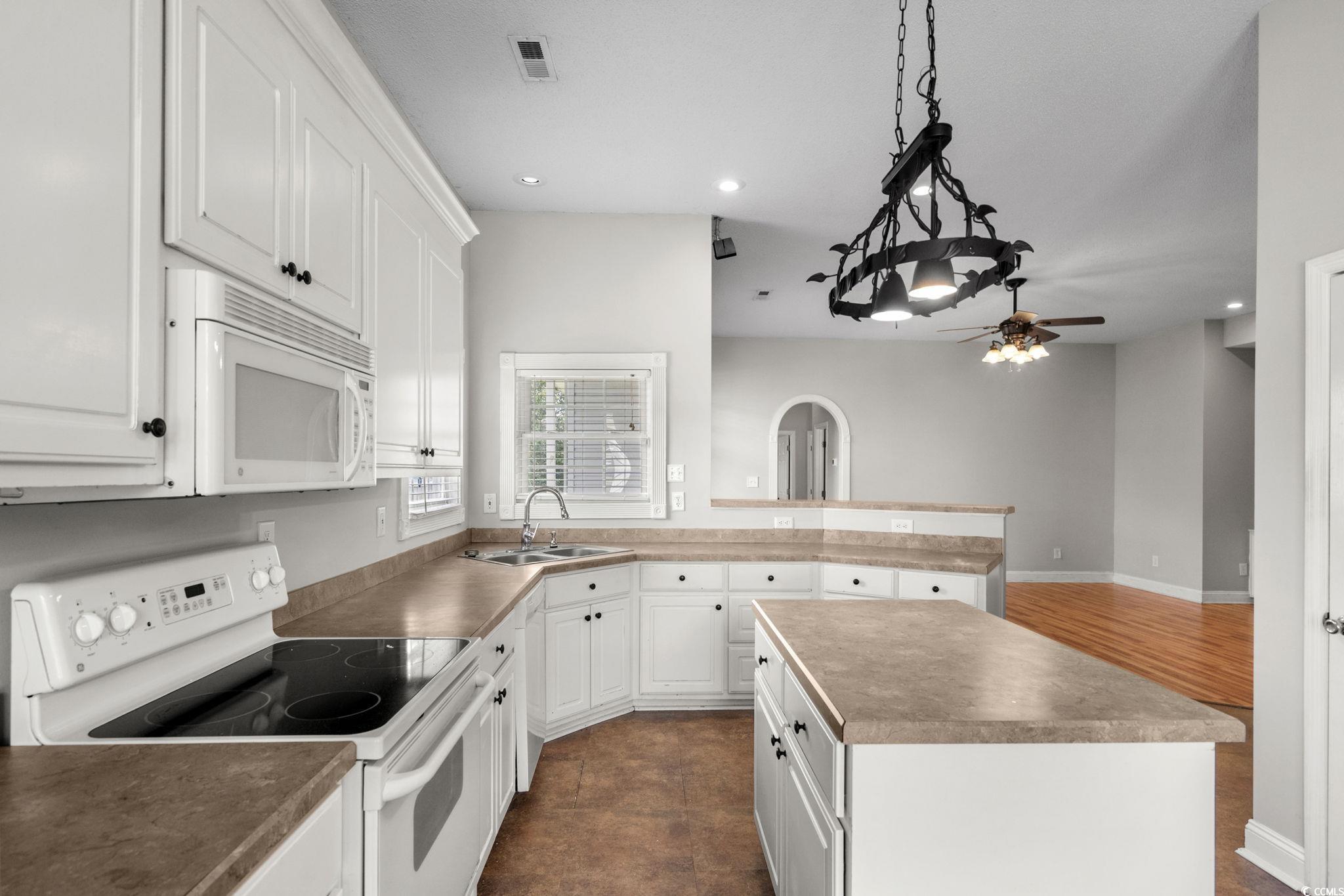 2723 Canvasback Trail Myrtle Beach, SC 29588 - Photo 16 of 40 Kitchen with white appliances, white cabinetry, recessed lighting, a ceiling fan, and pendant lighting
