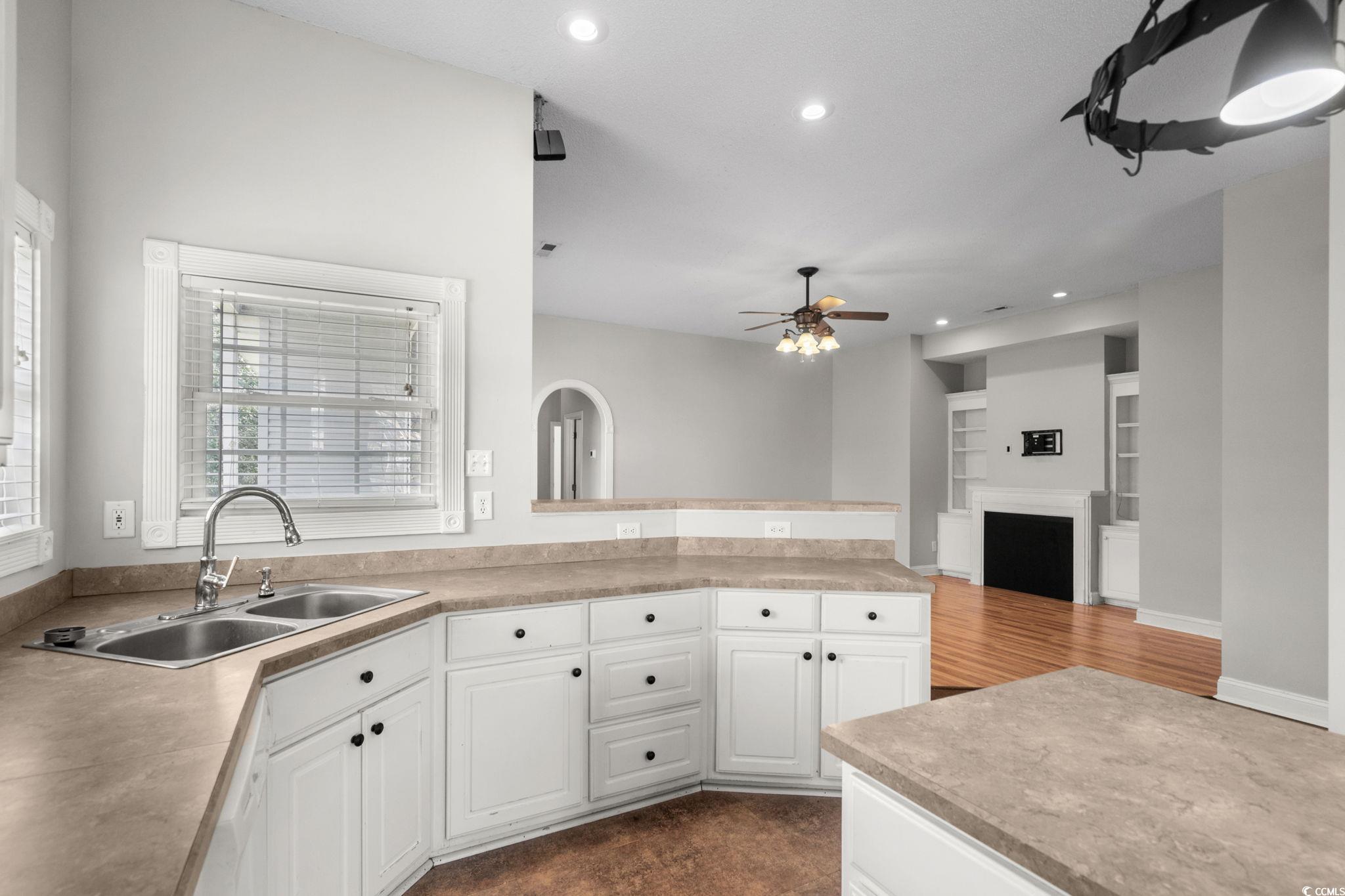 2723 Canvasback Trail Myrtle Beach, SC 29588 - Photo 17 of 40 Kitchen with white cabinets, light countertops, recessed lighting, ceiling fan, and a peninsula