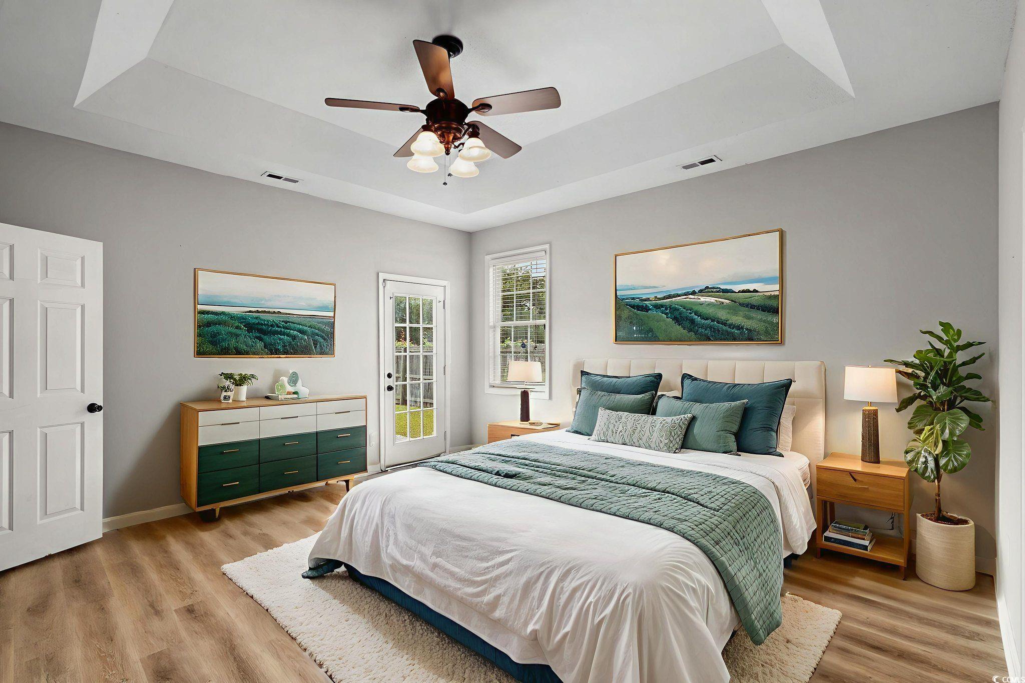 2723 Canvasback Trail Myrtle Beach, SC 29588 - Photo 18 of 40 Bedroom featuring a raised ceiling, access to exterior, and light wood finished floors