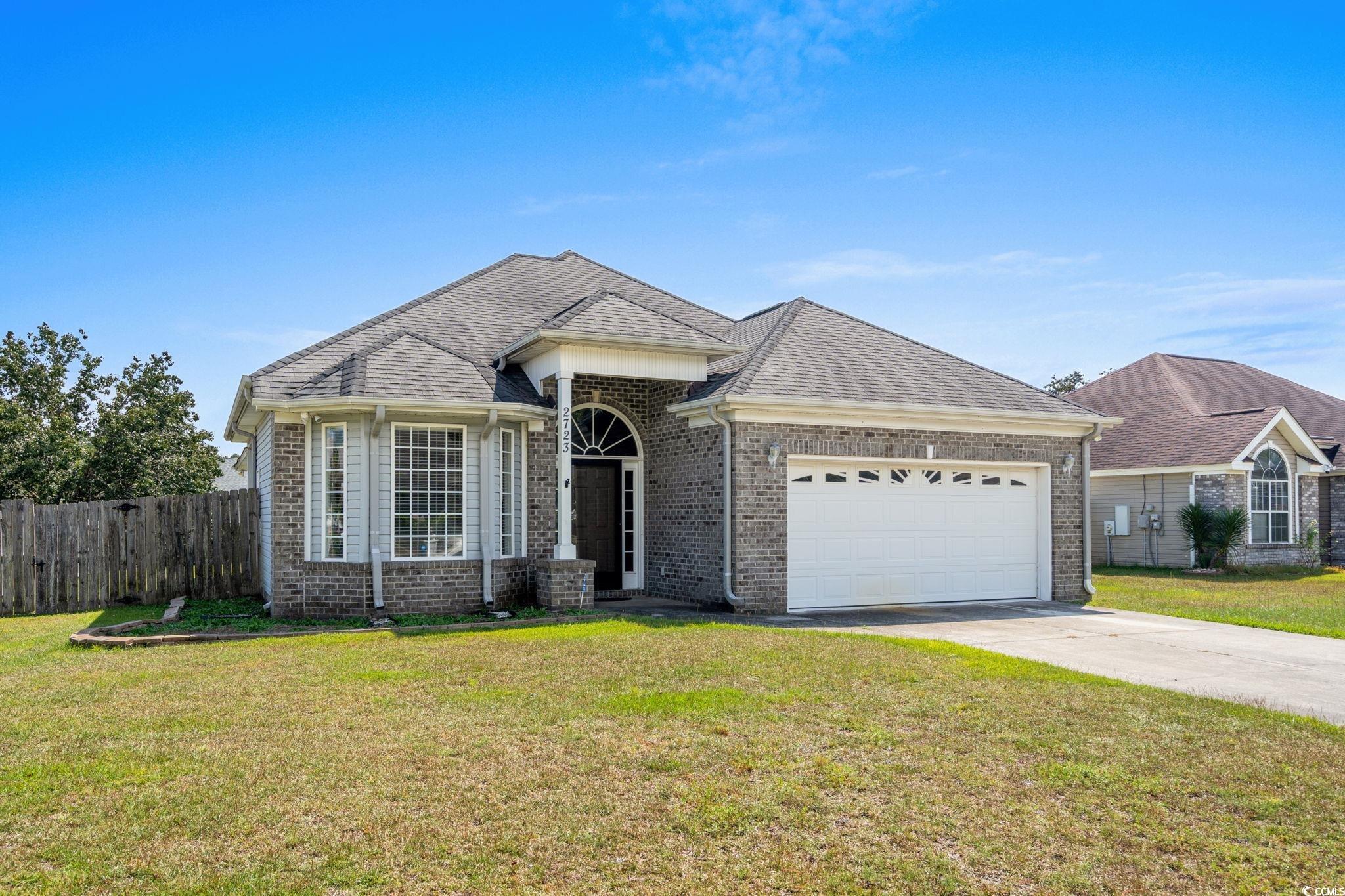 2723 Canvasback Trail Myrtle Beach, SC 29588 - Photo 2 of 40 Ranch-style home featuring brick siding, concrete driveway, a garage, and a shingled roof