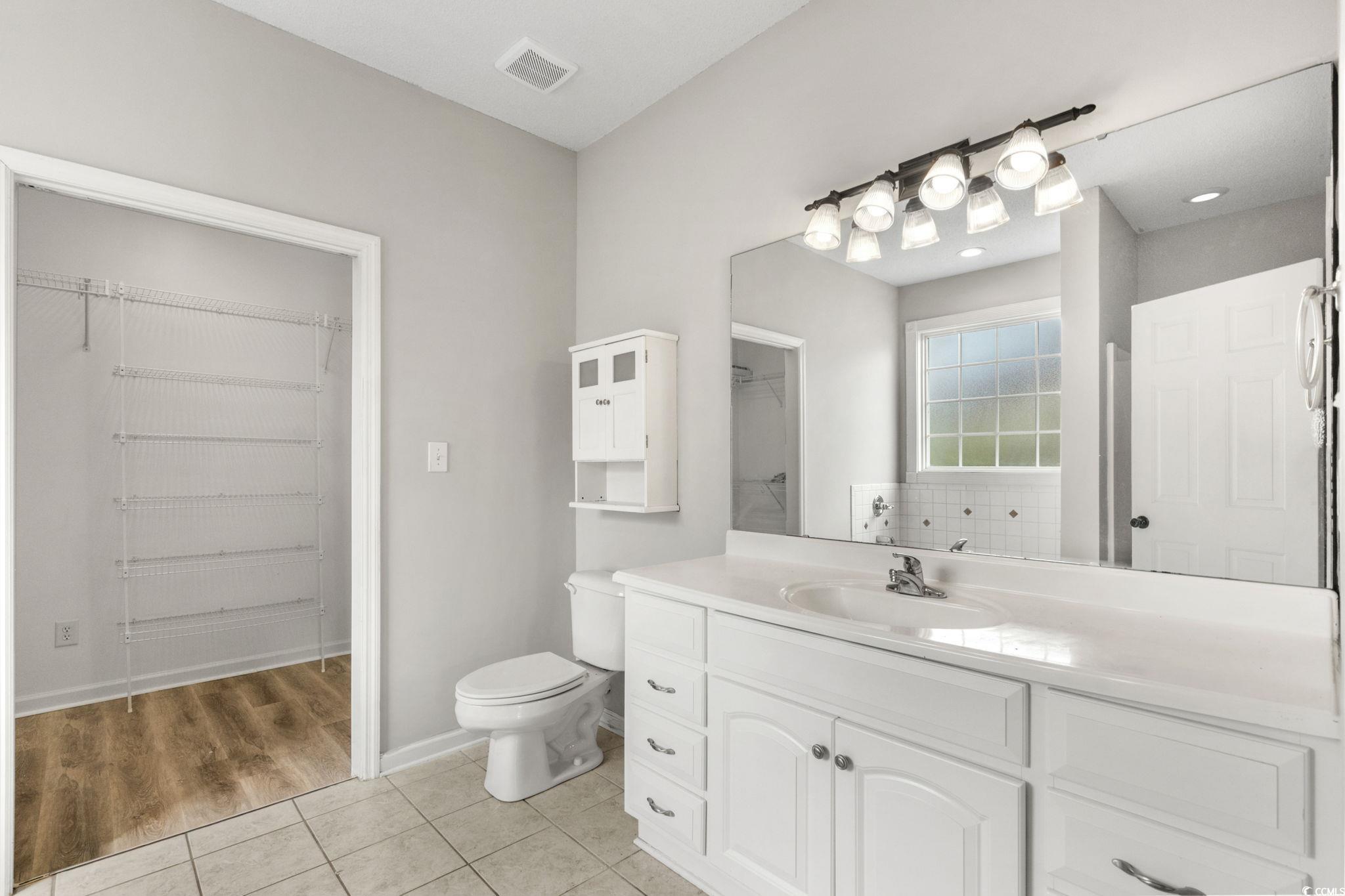 2723 Canvasback Trail Myrtle Beach, SC 29588 - Photo 21 of 40 Bathroom featuring light tile patterned floors, a spacious closet, and vanity