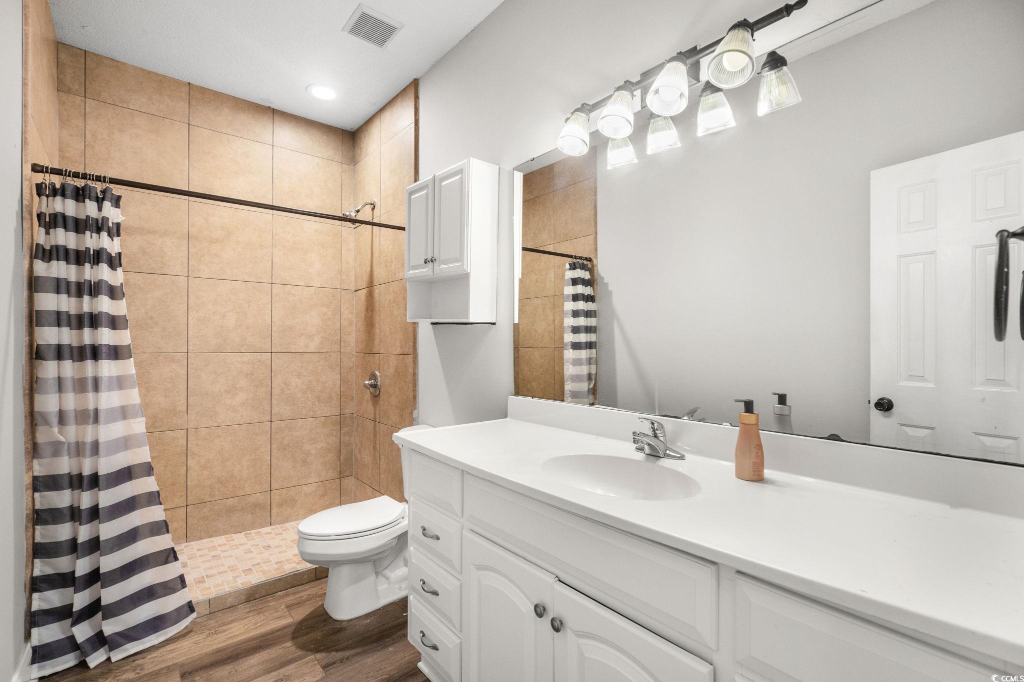 2723 Canvasback Trail Myrtle Beach, SC 29588 - Photo 26 of 40 Bathroom featuring vanity, a stall shower, dark wood-style floors, and recessed lighting