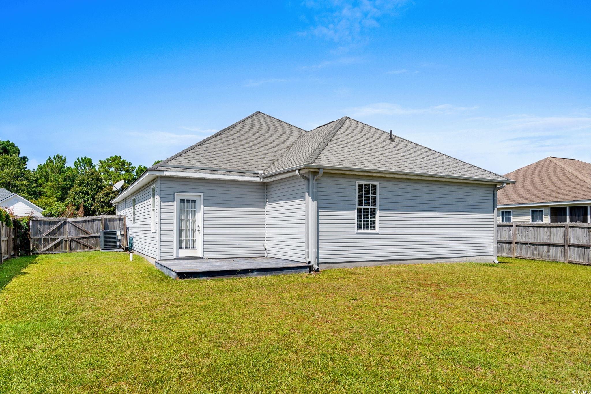 2723 Canvasback Trail Myrtle Beach, SC 29588 - Photo 32 of 40 Back of property featuring a deck, roof with shingles, a fenced backyard, and a gate
