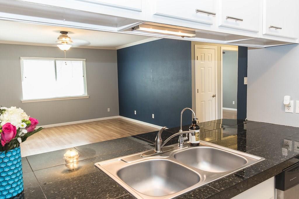 4209 Burnet Road, Unit 206 Austin, TX 78756 - Photo 8 of 20 A well-equipped kitchen overlooking a bright living space with durable laminate flooring.