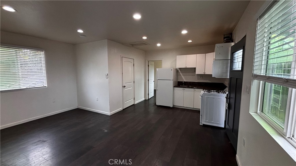 7922 Lindley Avenue Reseda, CA 91335 - Photo 4 of 11 a view of kitchen with stainless steel appliances granite countertop a stove and a refrigerator