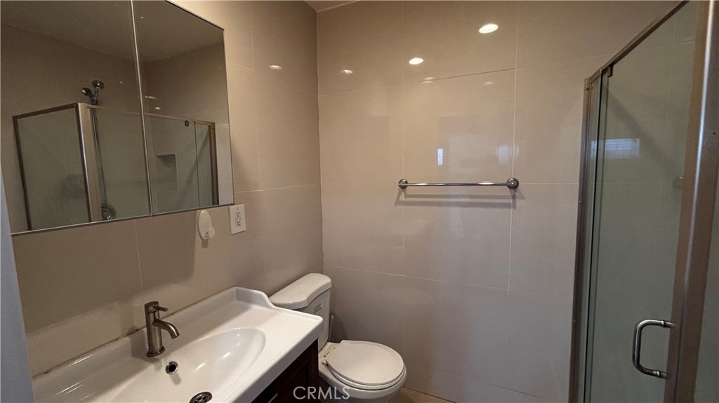 7922 Lindley Avenue Reseda, CA 91335 - Photo 7 of 11 a bathroom with a sink a toilet and shower