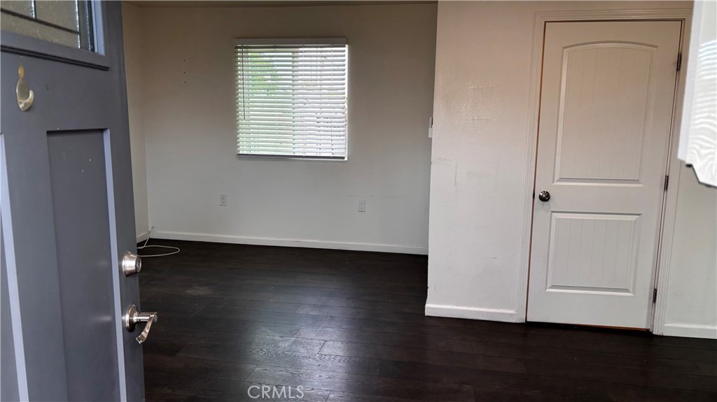 7922 Lindley Avenue Reseda, CA 91335 - Photo 10 of 11 an empty room with wooden floor and cabinet