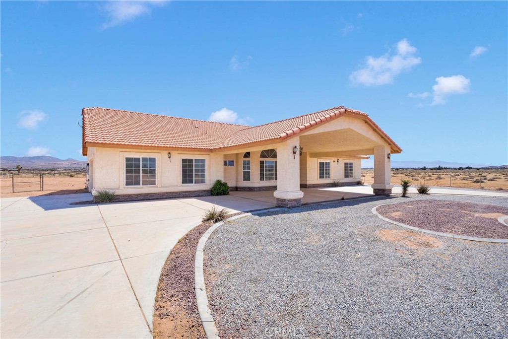 15090 Olema Road Apple Valley, CA 92307 - Photo 1 of 1 a front view of a house with a yard