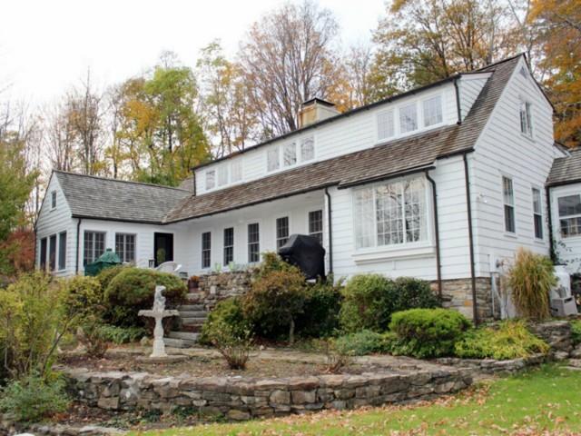 a front view of house with yard and trees around